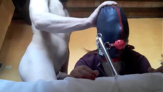 Tied to a machine masked and hooded Hot babe has to suck a big cock